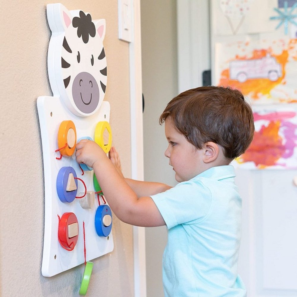 Activity Wall Panel Zebra,Activity Wall Panel Zebra: Engage, Learn, and Play! Introduce your child to a world of fun and learning with the Activity Wall Panel Zebra. This beautifully designed wall toy features a charming zebra shape and includes a geometry shape sorting puzzle, making it an engaging and educational addition to any play area. Key Features: Colour and Shape Recognition Geometry Shape Sorting Puzzle: Helps children recognize and differentiate various shapes and colors, enhancing their cognitiv