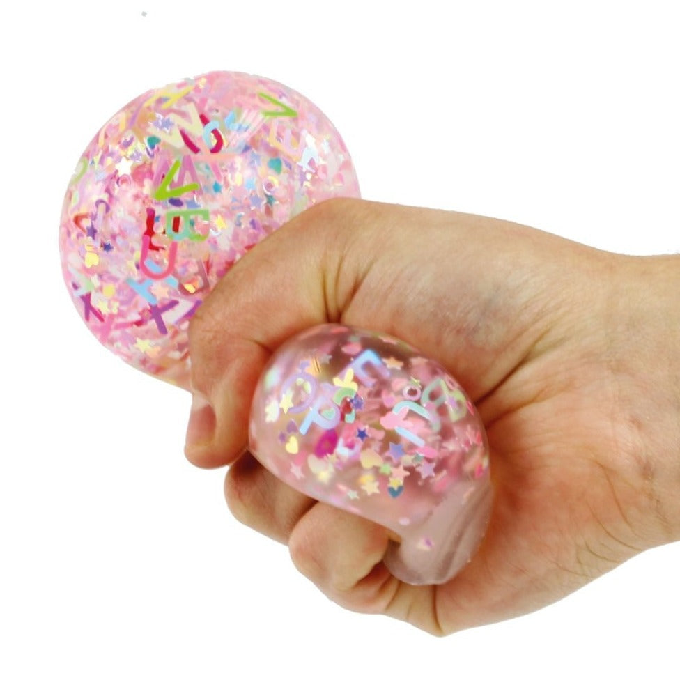 Alphabet Glitter Ball 60Mm,The Alphabet Glitter Balls are an innovative and captivating addition to the world of sensory toys, combining the benefits of a fidget toy, stress reducer, and hand strengthener all in one. Perfect for children who find solace and focus in the act of squeezing, these balls not only provide a satisfying tactile experience but also engage users on a visual level with their shimmering alphabet letters contained within. Key Features of the Alphabet Glitter Balls: Engaging Sensory Expe