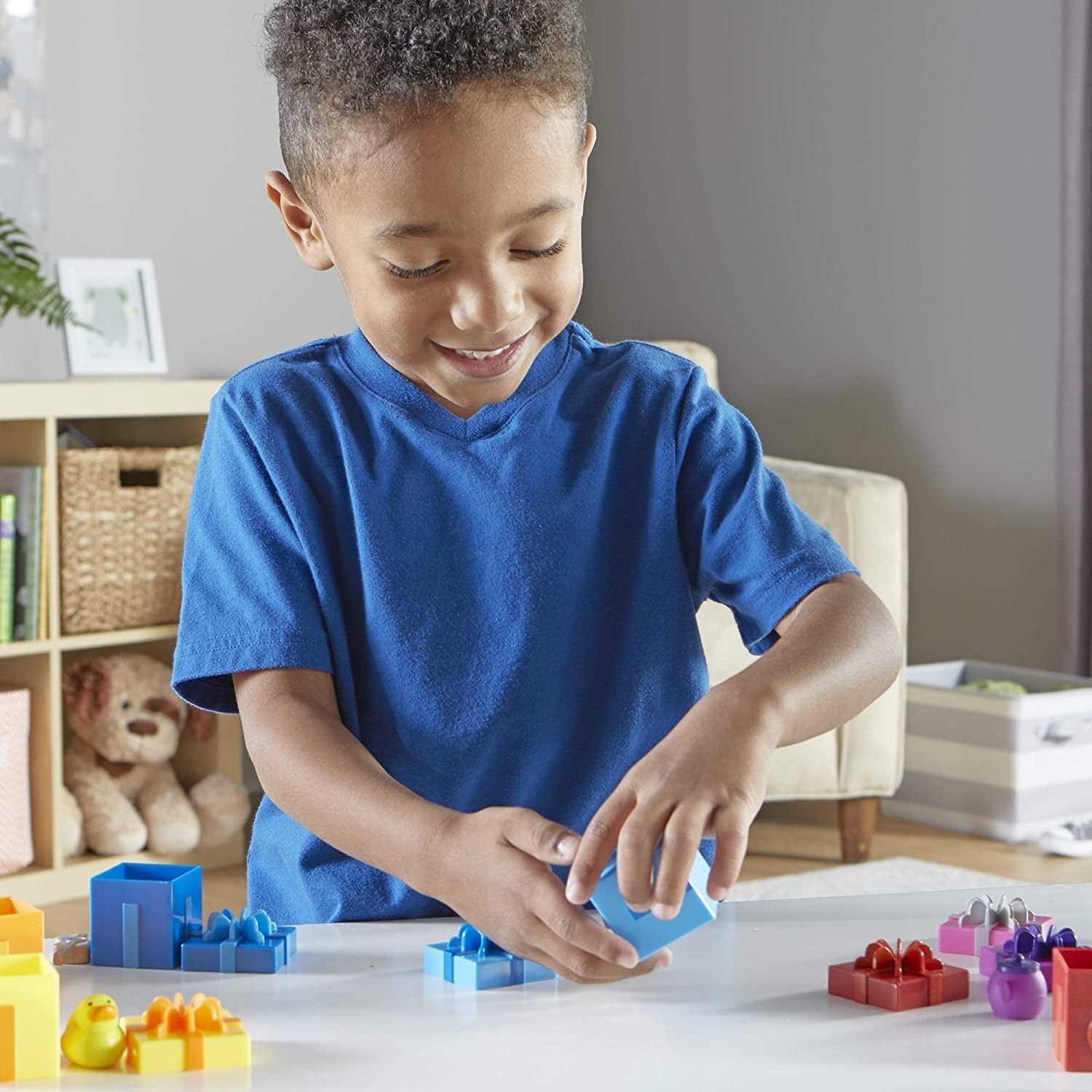 Counting Surprise Party,The Counting Surprise Party is a delightful learning toy designed to provide hours of educational fun for your child. This collection includes a range of numbered boxes, each containing a different colourful object. The boxes are adorned with numerals on the front and a dot array inside the lid, making it easy for children to match the lid to the correct numbered box. Each box is a treasure trove of fun, containing various objects from a friendly cat to a vibrant purple teapot. These