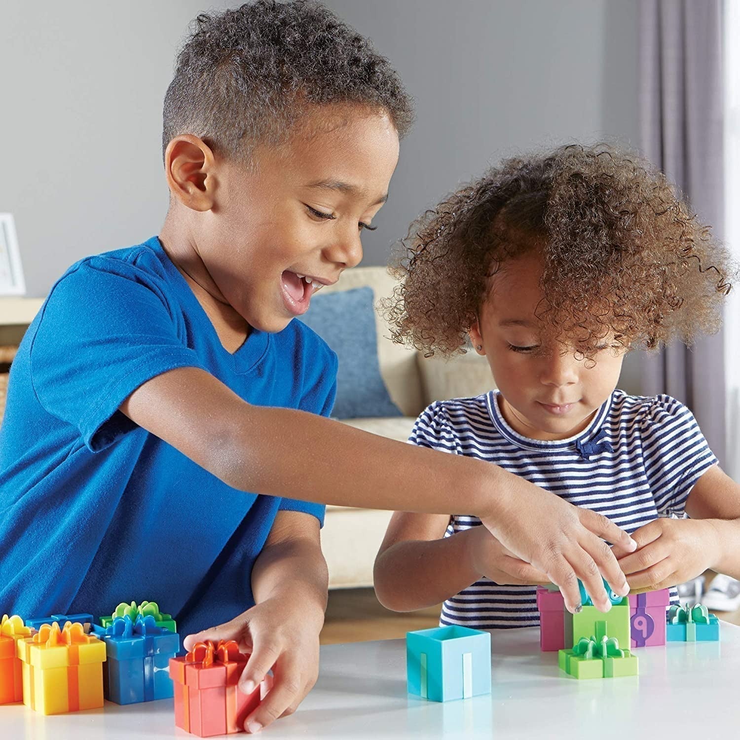 Counting Surprise Party,The Counting Surprise Party is a delightful learning toy designed to provide hours of educational fun for your child. This collection includes a range of numbered boxes, each containing a different colourful object. The boxes are adorned with numerals on the front and a dot array inside the lid, making it easy for children to match the lid to the correct numbered box. Each box is a treasure trove of fun, containing various objects from a friendly cat to a vibrant purple teapot. These