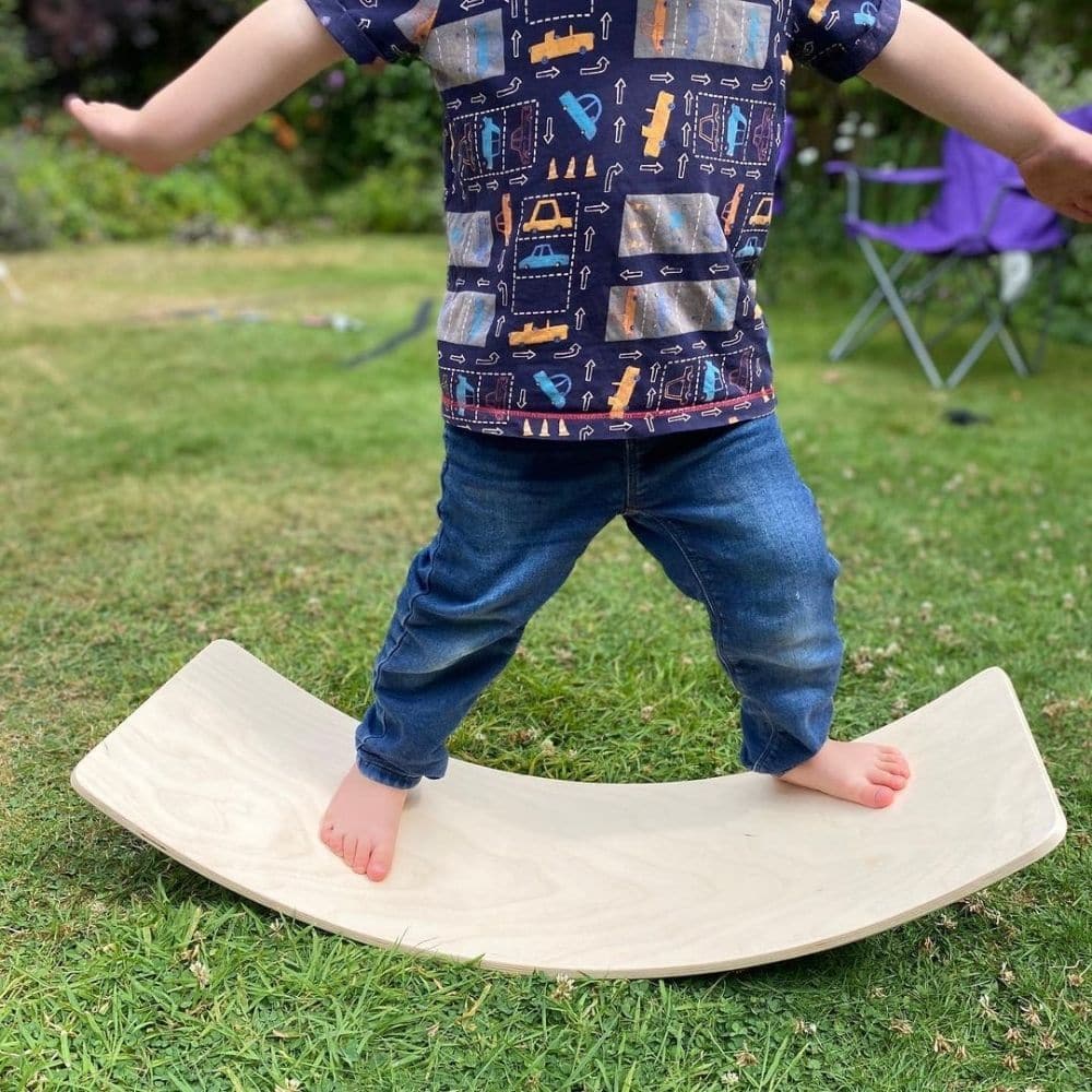 Curvy Balance Board,These Wooden Curvy Balance Boards do exactly what they say on the tin – the simplicity of the idea is what we love. Children can balance on the boards in many different positions – standing, lying or kneeling and when they are done with that, they can use it as a bridge to crawl under or pull their friend across the carpet. Such a simple idea, yet so much fun and so many variables! Your child develops: balancing, coordination, strength, gross motor skills, cognitive development, sensory 