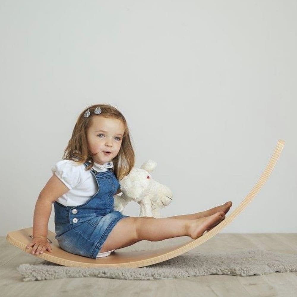 Curvy Balance Board,These Wooden Curvy Balance Boards do exactly what they say on the tin – the simplicity of the idea is what we love. Children can balance on the boards in many different positions – standing, lying or kneeling and when they are done with that, they can use it as a bridge to crawl under or pull their friend across the carpet. Such a simple idea, yet so much fun and so many variables! Your child develops: balancing, coordination, strength, gross motor skills, cognitive development, sensory 