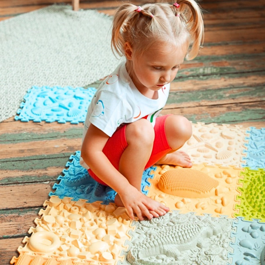 Jolly Feet Play Mats Young Explorer,Are you ready for an adventure? Bits from different places around the Earth await you on a safe, mood-enhancing journey around the world! With sharp and smooth surfaces and an array of nature-themed textures, the Jolly Feet Play Mats invite young explorers to embark on new and exciting sensory trips. Let’s go for new impressions, young explorer! Key Features Diverse Textures and Colours: The wide range of mat textures and colours stimulate the imagination, providing varie