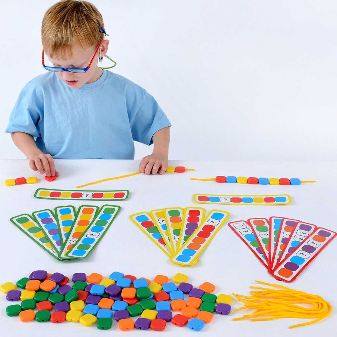 Lacing Colour Sequence Beads,Introducing our brightly coloured set of 96 beads, 12 strings, and 18 double-sided work cards, perfect for children who are learning patterns and sequencing skills. The set includes 16 beads of each colour - red, yellow, blue, green, orange, and purple - with each bead measuring 2.5cm square. The laces are 30cm long, allowing children to easily thread the beads onto the strings.The Lacing Colour Sequence Beads set comes with three levels of colour-coded work cards to cater to di