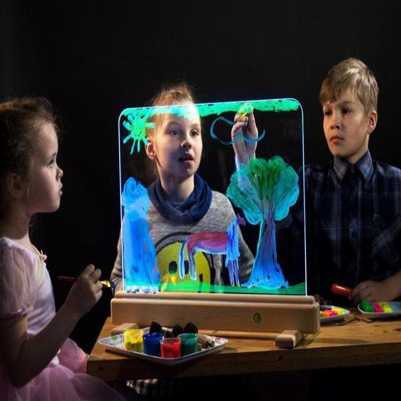 Magic Light Easel,The Magic Light Easel has magic tempered glowing glass on which you can paint on. Control unit of the device allows you to select from the range of 16 colours of the base lighting and every time create a new masterpiece. You can create a different impression of your piece of art only by changing the lighting. So, you should not immediately wipe out the landscapes you have created – change the colour and enjoy undiscovered ornaments of the drawing. Unlike a paper drawing that cannot be eras