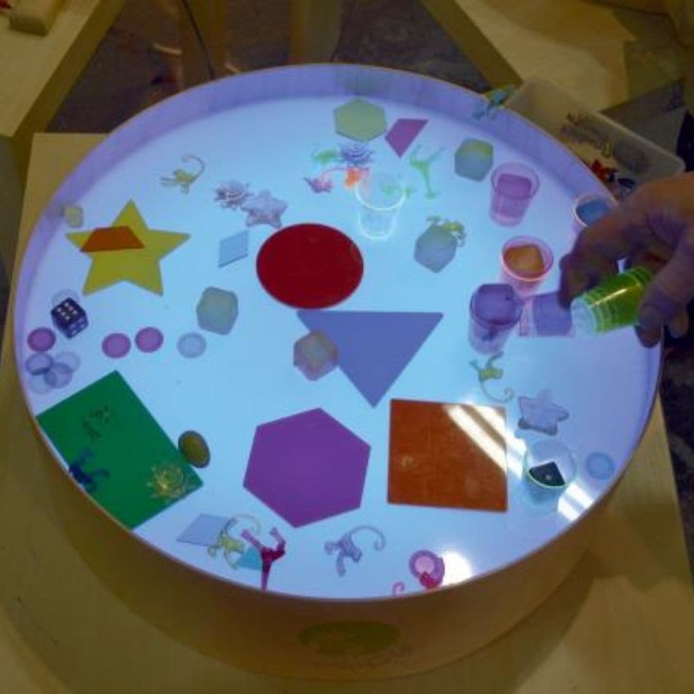 Magic Light Table,Introducing the Magic Light Table, a versatile and engaging tool for children's games, art projects, and therapeutic activities. This compact, lightweight table is designed with a high edge to keep materials like sand and semolina contained while children create and explore. Key Features of the Magic Light Table: Vibrant Lighting Options: Equipped with LED RGB diodes, the table offers 16 different colours and four automatic colour change programs, adding a dynamic element to play and creat