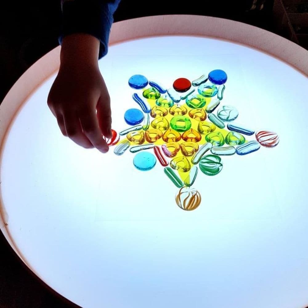 Magic Light Table,Introducing the Magic Light Table, a versatile and engaging tool for children's games, art projects, and therapeutic activities. This compact, lightweight table is designed with a high edge to keep materials like sand and semolina contained while children create and explore. Key Features of the Magic Light Table: Vibrant Lighting Options: Equipped with LED RGB diodes, the table offers 16 different colours and four automatic colour change programs, adding a dynamic element to play and creat