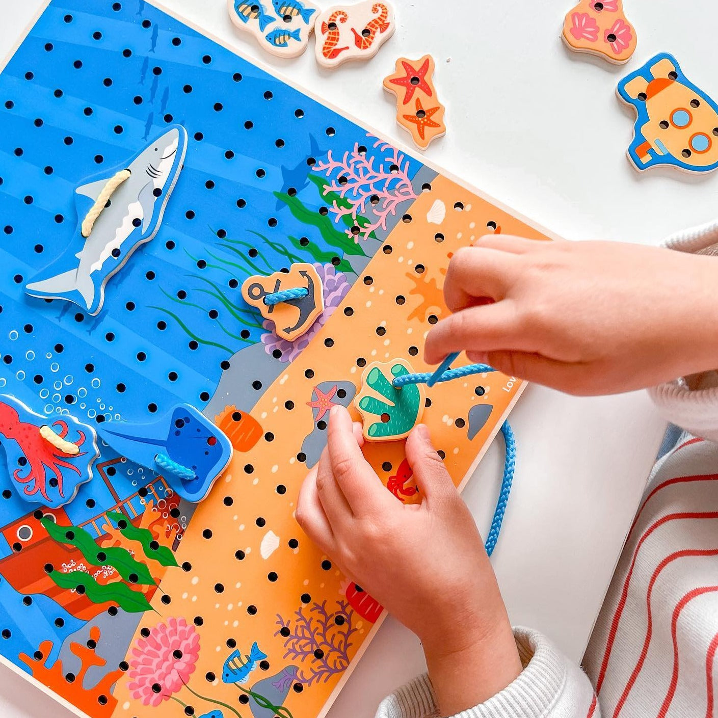 Marine Lace-A-Shape,Ready for an under the sea adventure? Thread the laces through the marine shapes and onto the baseboard to create an exciting sea scene. Wooden threading toys are a fun way to develop kids’ hand-eye coordination, fine motor and sequencing skills. Our Marine Lacing Game For Toddlers features 30 different marine-inspired shapes and six different coloured laces. Youngsters need to simply thread the laces through the shapes and onto the baseboard to create a picture. Made from high quality, 