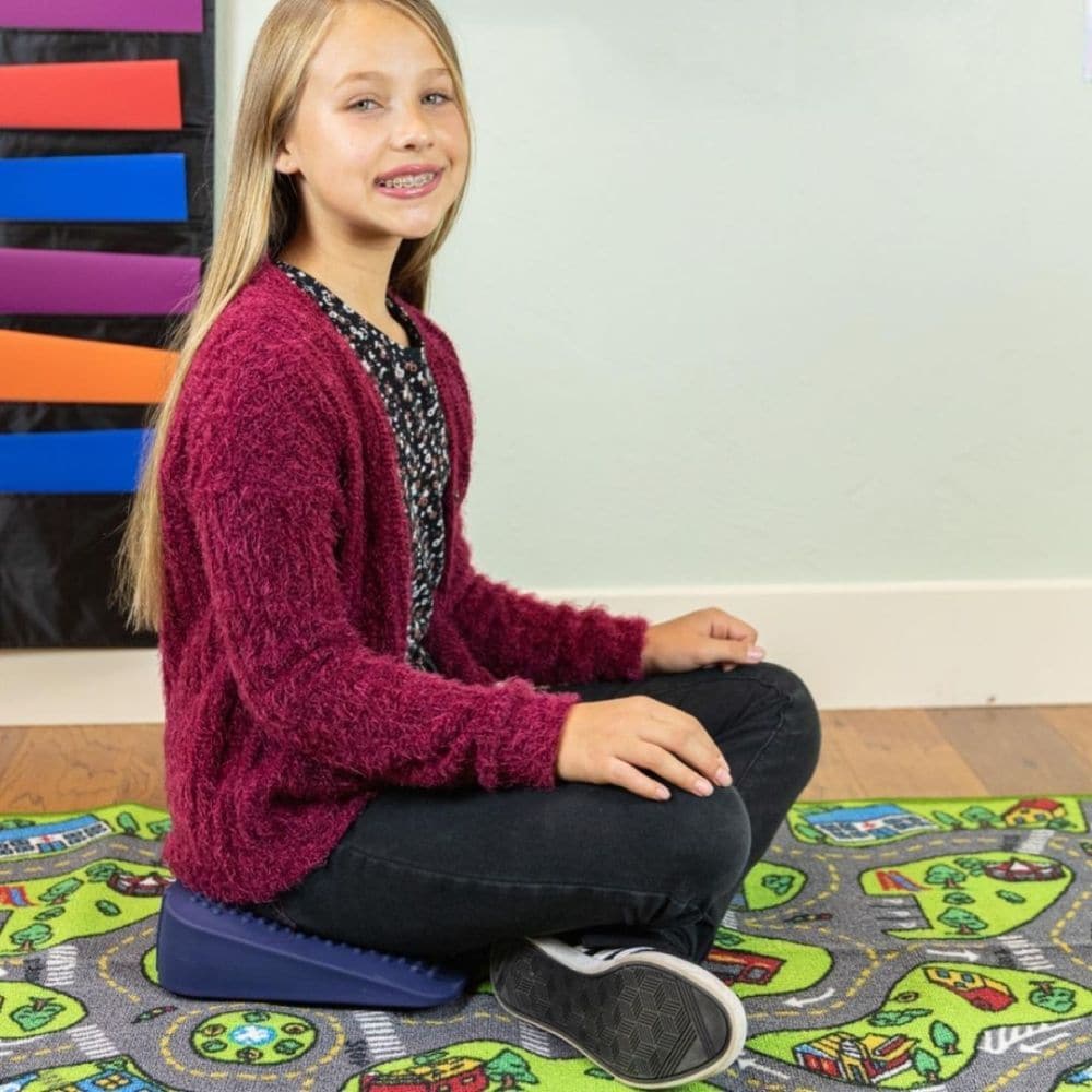 Move And Sit Seat Wedge,Movin’ Sit Jr Wedge: Enhance Comfort and Posture for Children The Movin’ Sit Jr Wedge is thoughtfully designed for children, making it a perfect addition to classroom chairs, dining tables, or even for moments of quiet time on the floor. This innovative seat wedge combines the benefits of a therapy ball and a wedge, providing a unique sensory experience that promotes proper posture and core strength. Features and Benefits: Sensory and Therapeutic Benefits Simulates Motion: The Movin’