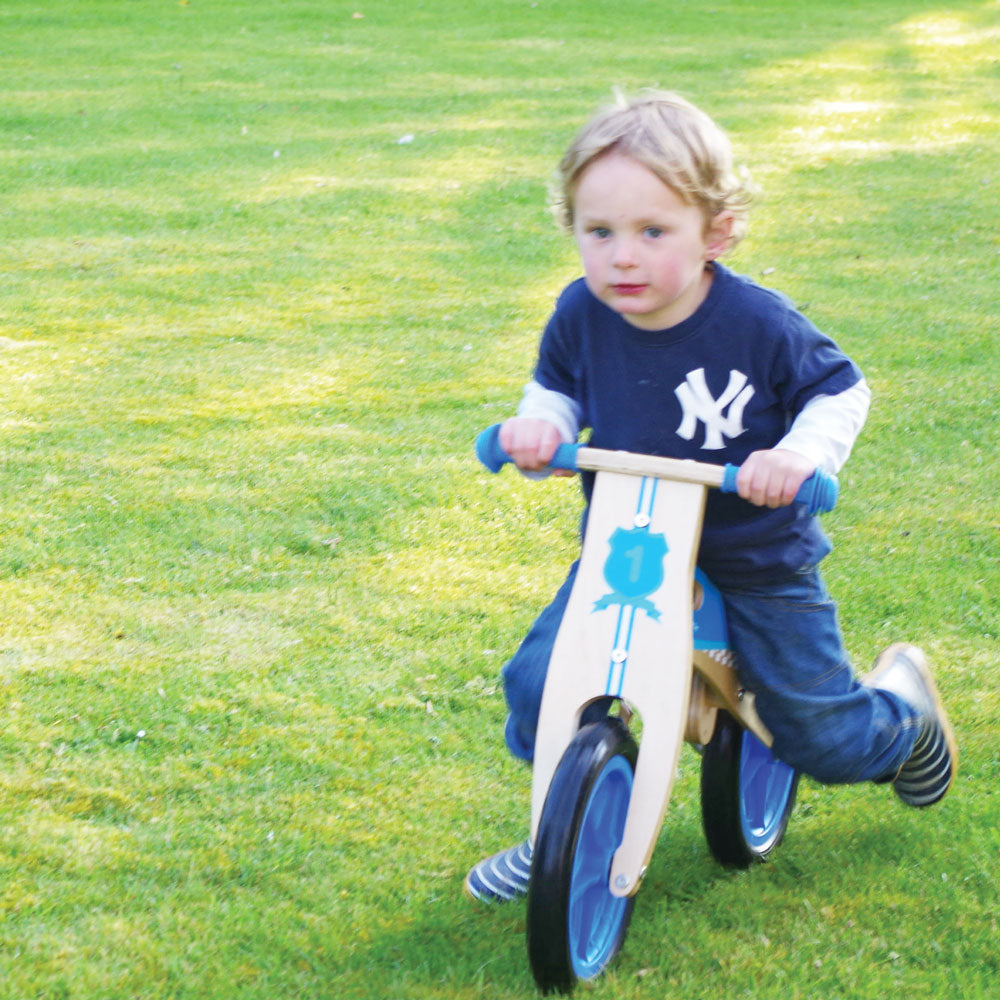 My First Balance Bike Blue,Introduce your little one to the joy of mobility with My First Balance Bike in Blue. Crafted from sturdy wood and designed with young riders in mind, this balance bike is the perfect way for toddlers to kick-start their journey towards two-wheeled adventures. Featuring a sleek blue design, this wooden balance bike is as stylish as it is functional. With its padded and adjustable seat, solid tyres, and easy-to-grip handlebars, it offers young riders a comfortable and secure riding 