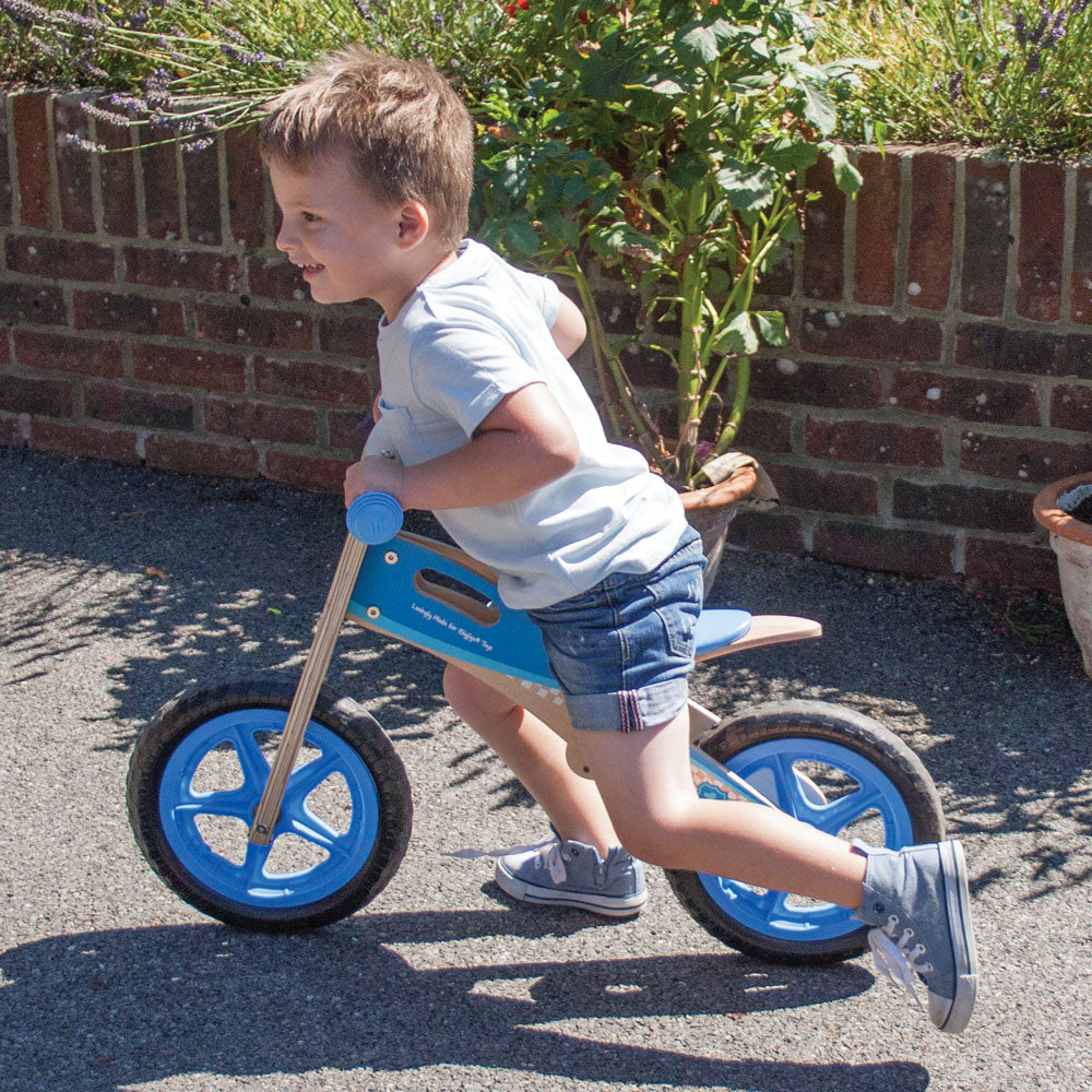 My First Balance Bike Blue,Introduce your little one to the joy of mobility with My First Balance Bike in Blue. Crafted from sturdy wood and designed with young riders in mind, this balance bike is the perfect way for toddlers to kick-start their journey towards two-wheeled adventures. Featuring a sleek blue design, this wooden balance bike is as stylish as it is functional. With its padded and adjustable seat, solid tyres, and easy-to-grip handlebars, it offers young riders a comfortable and secure riding 