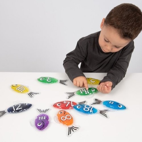 Rainbow Gel Number Fish,Vibrantly rainbow coloured Rainbow Gel Number Fish with numbers 0-20 on one side and their corresponding dots on the other. The Rainbow Gel Number Fish are Ideal for learning to count, to associate numbers with quantities, for colour recognition and for sensory play. The tactile squashy Rainbow Gel Number Fish contain gel-like beads in 7 crystal clear rainbow colours, with a loop at the top for hanging on a string or with pegs. The translucent colours contained within the Rainbow Gel