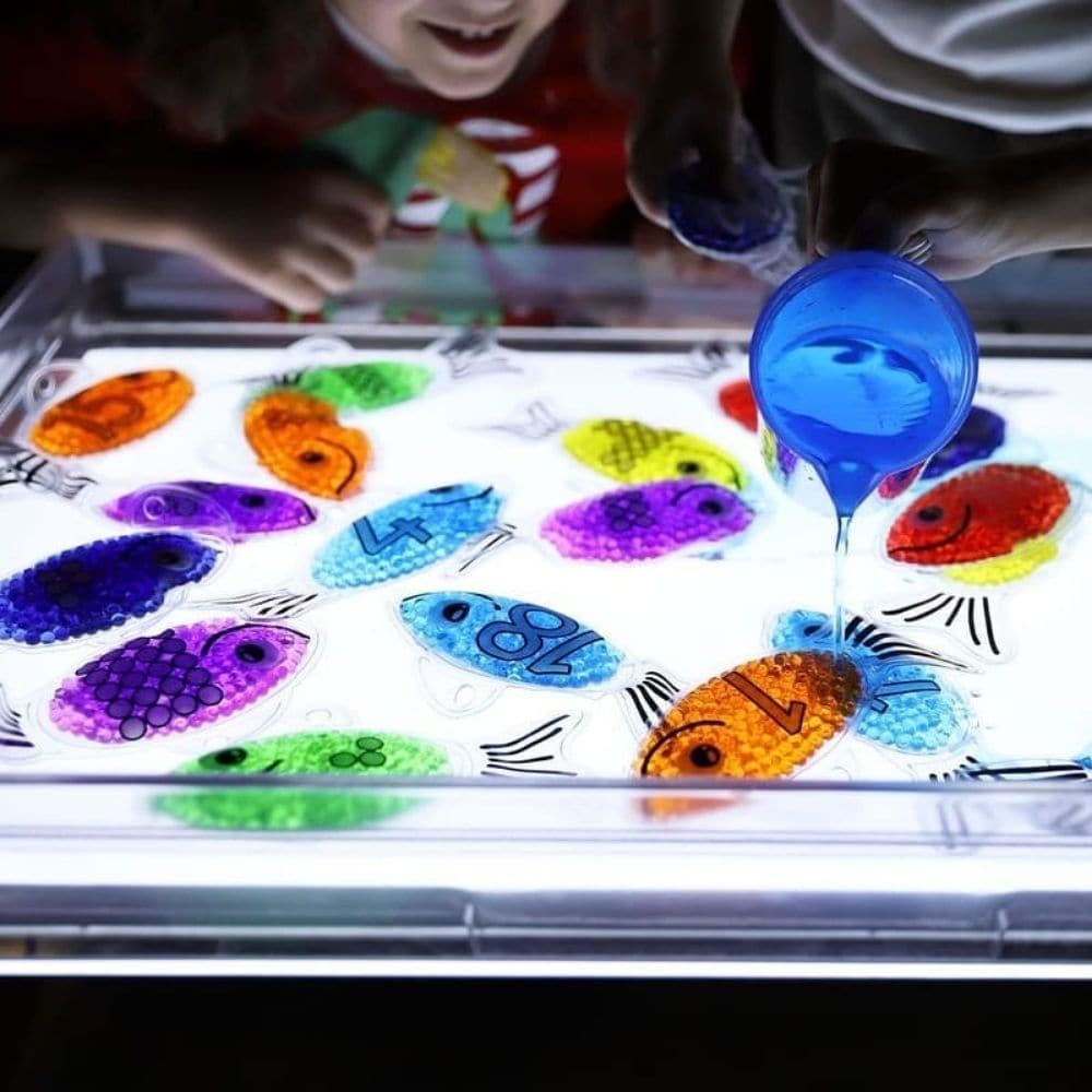 Rainbow Gel Number Fish,Vibrantly rainbow coloured Rainbow Gel Number Fish with numbers 0-20 on one side and their corresponding dots on the other. The Rainbow Gel Number Fish are Ideal for learning to count, to associate numbers with quantities, for colour recognition and for sensory play. The tactile squashy Rainbow Gel Number Fish contain gel-like beads in 7 crystal clear rainbow colours, with a loop at the top for hanging on a string or with pegs. The translucent colours contained within the Rainbow Gel