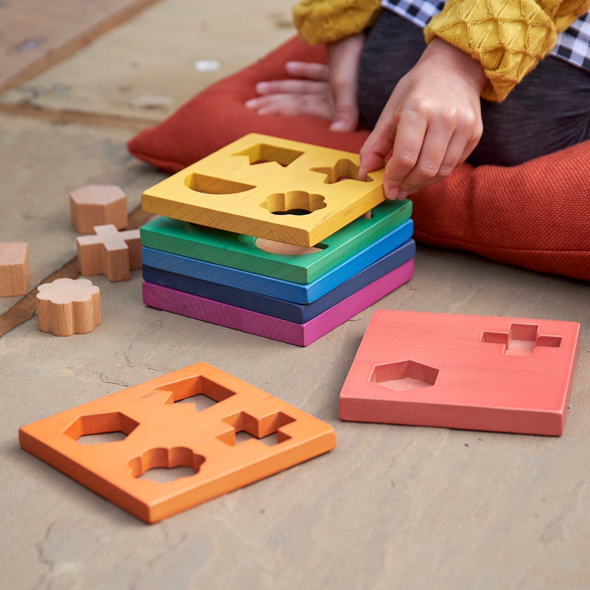 Rainbow Wooden Shape Stacker,Our TickiT® Rainbow Wooden Shape Stacker is a colourful and fun puzzle to help your child with shape recognition and problem solving skills. Made from beautiful smooth solid beechwood with a natural woodgrain finish in the 7 different colours of the rainbow. The 12 tactile shape cut outs nest inside a rounded square panel so your child can practice fitting them into their matching shaped hole or stack them to build a rainbow shape tower. The wooden panels are red, orange, yellow