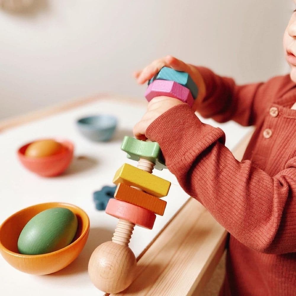 Rainbow Wooden Shape Twister,TickiT® Rainbow Wooden Shape Twister Our TickiT® Rainbow Wooden Shape Twister is a beautifully crafted educational toy made from smooth, solid beechwood with a natural woodgrain finish. Featuring the seven different colours of the rainbow, this giant bolt comes with seven nuts in various shapes, each with a different number of edges ranging from 1 (a circle) to 8 (an octagon). Key Features: Beautiful and Tactile: Smooth Beechwood: Made from high-quality beechwood, providing a na