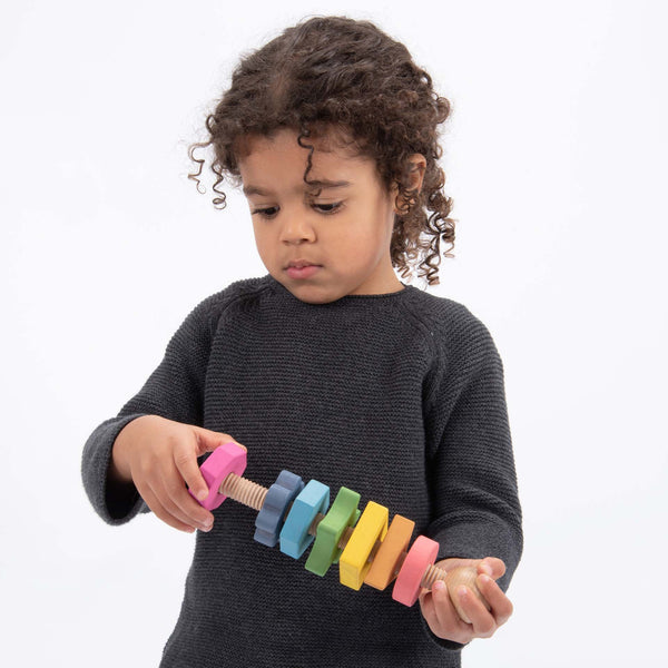 Rainbow Wooden Shape Twister,TickiT® Rainbow Wooden Shape Twister Our TickiT® Rainbow Wooden Shape Twister is a beautifully crafted educational toy made from smooth, solid beechwood with a natural woodgrain finish. Featuring the seven different colours of the rainbow, this giant bolt comes with seven nuts in various shapes, each with a different number of edges ranging from 1 (a circle) to 8 (an octagon). Key Features: Beautiful and Tactile: Smooth Beechwood: Made from high-quality beechwood, providing a na